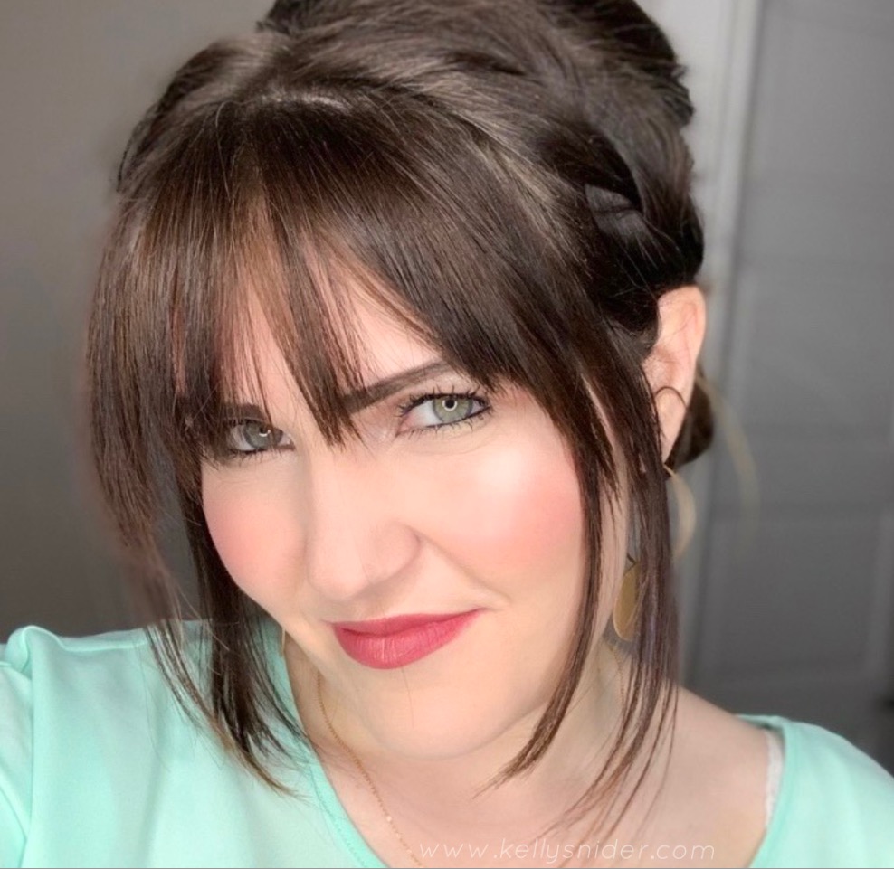 How to Contour in 5 Easy Steps by popular beauty blogger and top artist with Maskcara Beauty, Kelly Snider; Image of Brunette woman with bangs and read lips wearing Maskcara Beauty's iiiD foundation.