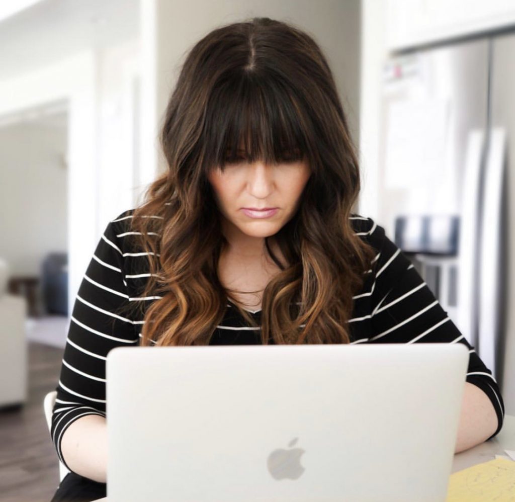 Popular Utah Blogger and Independent Maskcara Artist, Kelly Snider addresses MLM jobs for stay-at-home moms; image of female attorney working from home on her laptop.