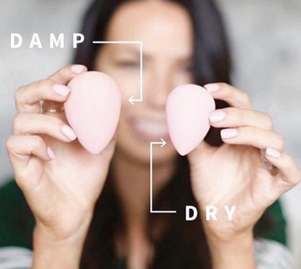 How to use a makeup sponge in 3 simple steps by popular blogger and seint artist, Kelly Snider. Image of a Cara Brooke holding a wet and dry seint perfector sponge.