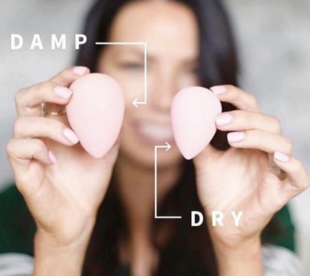 How to use a makeup sponge in 3 simple steps by popular blogger and seint artist, Kelly Snider. Image of a Cara Brooke holding a wet and dry seint perfector sponge. 