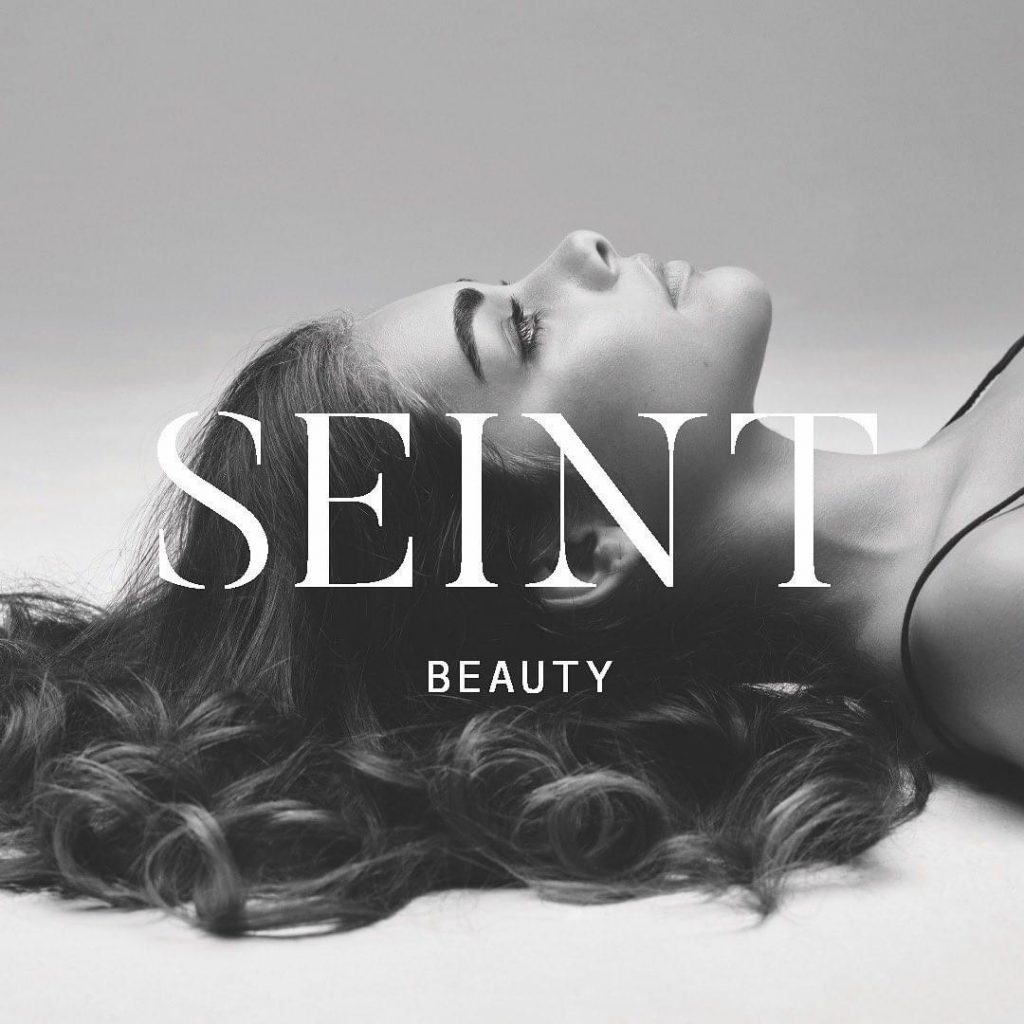 Image of the side of a model's face, lying down, with the words Seint Beauty across the center of the screen.