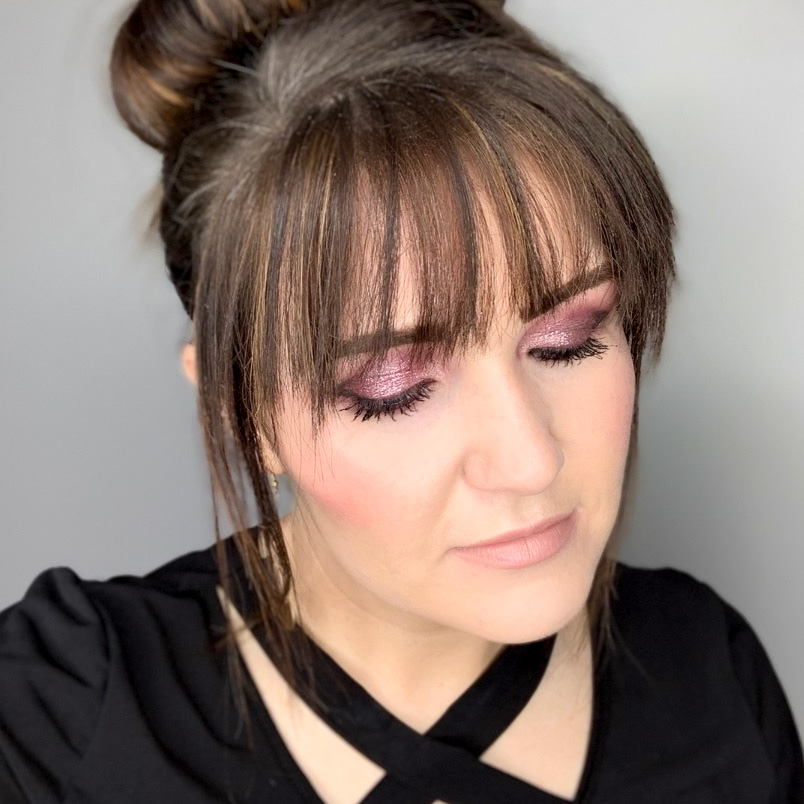 Kelly Snider modeling a purple Seint eyeshadow look created with her custom eyeshadow palette